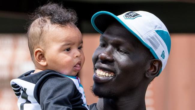 Aliir Aliir with his baby Mayom at Port Adelaide training. Picture: Port Adelaide Instagram