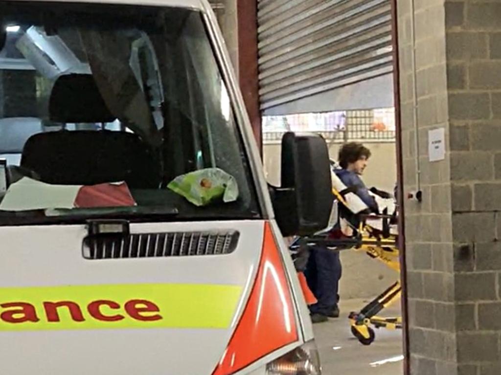 Sydney CBD attacker being escorted from Day Street Police station to the hospital. Source: Elias Visontay