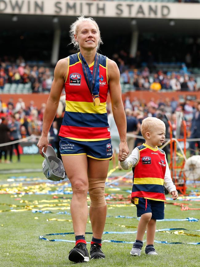 Crows star Erin Phillips soaks up her side’s AFLW grand final win over Carlton in March, and walks around Adelaide Oval with her son Blake. Picture: MICHAEL WILLSON/AFL PHOTOS