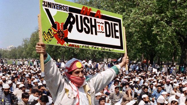 A man holds a sign calling for the death of British author Salman Rushdie near the Westminster Bridge in London. Picture: AFP