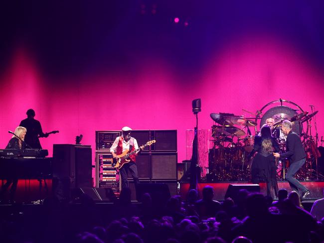 Fleetwood Mac performing in Sydney, Lindsey Buckingham - lead guitar, rhythm guitar, vocals, Stevie Nicks - vocals, tambourine, Christine McVie - vocals, keyboards, maracas, accordion on 