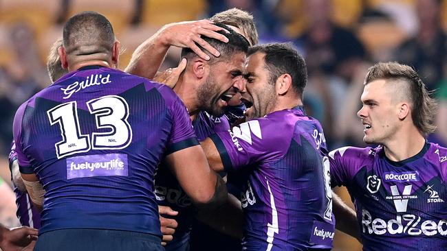 Jesse Bromwich and Cameron Smith celebrate Melbourne’s flying start against the Raiders. Picture: Getty Images