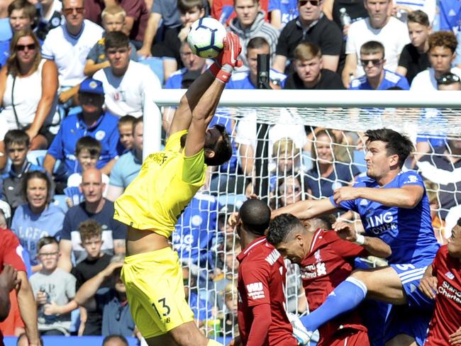 Liverpool's goalkeeper Alisson, center, makes a save during the English Premier League soccer match between Leicester City and Liverpool at the King Power Stadium in Leicester, England, Saturday, Sept. 1, 2018. (AP Photo/Rui Vieira)