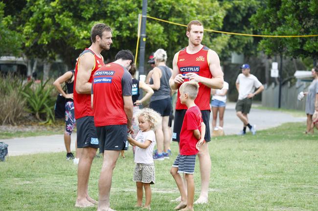 Gold Coast Suns players Sam Day (left) and Rory Thompson (right) during their community beach event at Palm Beach. Picture: Tertius Pickard