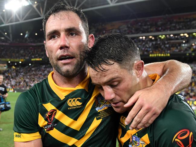 Cameron Smith of Australia (left) and teammate Cooper Cronk celebrate winning the Rugby League World Cup final match between the Australian Kangaroos and England at Brisbane Stadium in Brisbane, Saturday, December 2, 2017. (AAP Image/Dan Peled) NO ARCHIVING, EDITORIAL USE ONLY