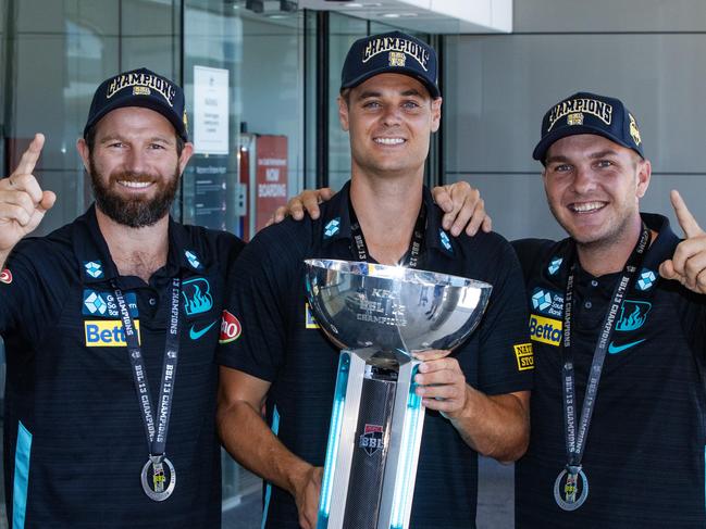 BBL Champions of 2023/24 Brisbane Heat arrive at Brisbane Airport.Michael Neser, Spencer Johnson and Josh Brown with the BBL trophy at Brisbane Airport.Picture: Nigel Hallett