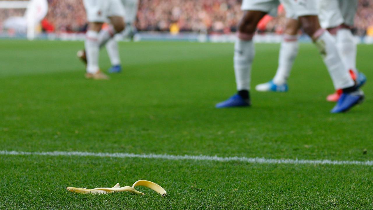 A banana thrown from the crowd is seen at the side of the pitch