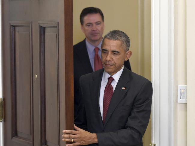 President Barack Obama, followed by FBI Director James Comey, arrives in the Roosevelt Room of the White House in Washington. Picture: AP