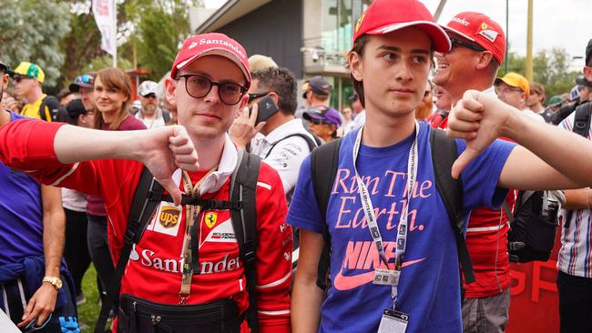 Spectators react as they leave after waiting at the gate and being told that the Australian Grand Prix has officially been cancelled. Picture: AAP Image/Scott Barbour