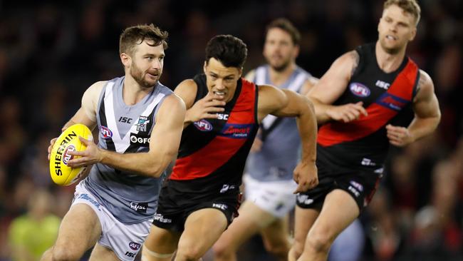 Port Adelaide’s Sam Gray is chased by Essendon’s Dylan Shiel (middle) and Jake Stringer during the round 20 match at Marvel Stadium. Picture: MICHAEL WILLSON / AFL Photos via Getty Images