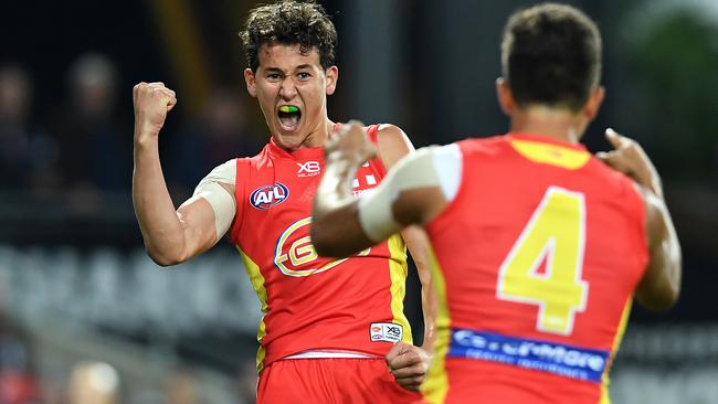 Will Powell celebrates a goal with his first kick on his AFL debut.