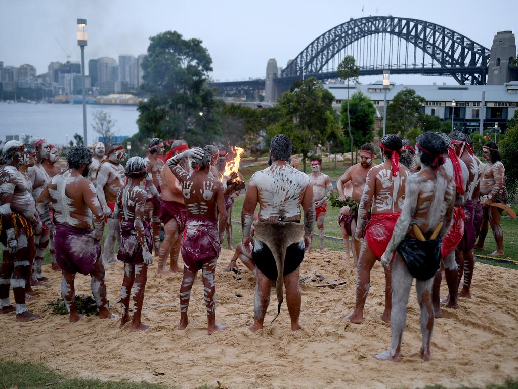 Koomurri people and representatives of Aboriginal groups from around Australia perform the Smoking Ceremony and Dance during the WugulOra Morning Ceremony at Walumil Lawn at Barangaroo Reserve as part of Australia Day celebrations in Sydney Picture: AAP Image/Brendan Esposito