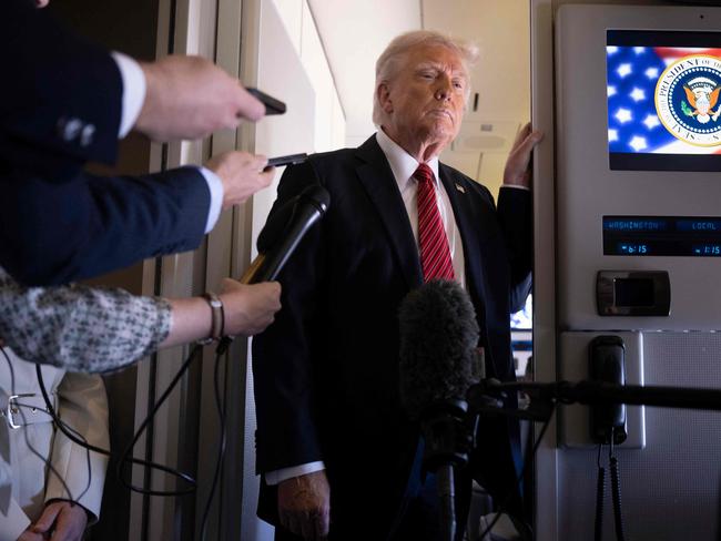 US President Donald Trump listens to questions as he speaks to members of the press on Air Force One while flying over Saudi Arabia on his way to Qatar on May 14, 2025. (Photo by Brendan Smialowski / AFP)