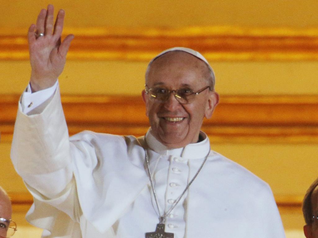 Pope Francis waves to the crowd from the central balcony of St. Peter's Basilica at the Vatican, on March 13, 2013. Picture: AP