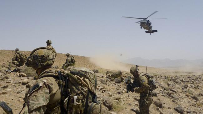 Australian Army soldiers from Special Operations Task Group prepare to be extracted by a US Army Black Hawk helicopter alongside their Afghan National Security Force partners after completing the clearance of a cave system in Uruzgan province, southern Afghanistan, in 2012. Picture: Department of Defence