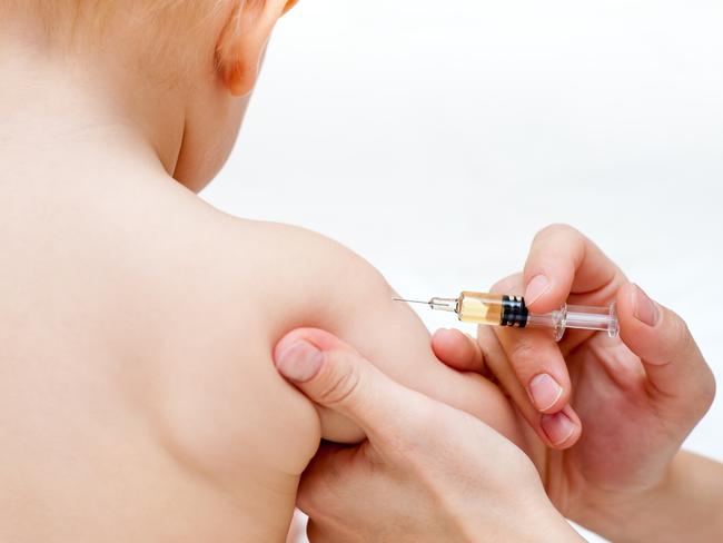 A baby gets an injection. Vaccination. Child. Syringe. Generic image.