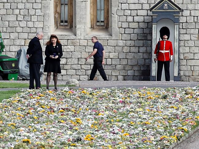 Prince Andrew, Duke of York and Sarah, Duchess of York look at floral tributes laid by people near Windsor Castle. Picture: Reuters