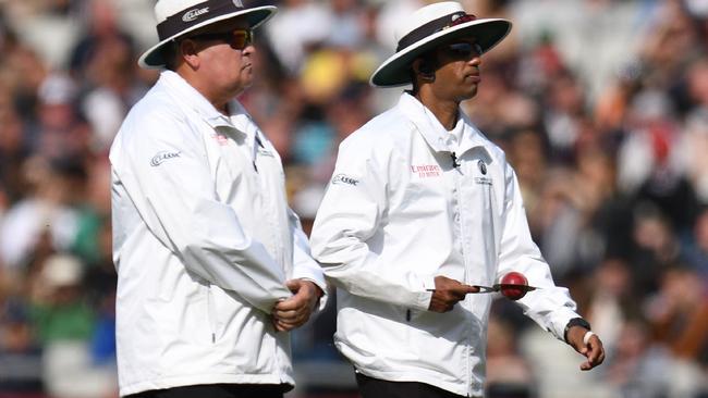 Umpires Marais Erasmus and Kumar Dharmasena wait for a replacement ball. Picture: AFP