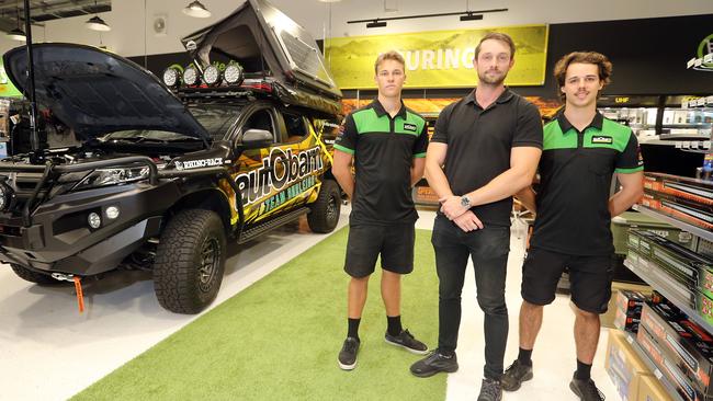 Several Gold Coast businesses have rallied around a Supercheap Auto worker who was stood down after he was involved in a viral video. Autobarn's Michael Farrar is one of them. He is pictured with staff members Beau Batchelor (L) and Matt Mihelcic. Picture: Richard Gosling