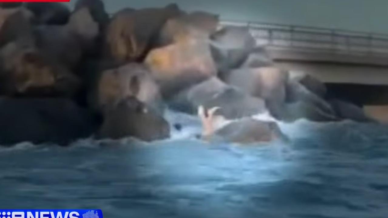 A boy was drowning, after falling from rocks and becoming caught in a rip about 20m from shore. Picture: 9 NEWS