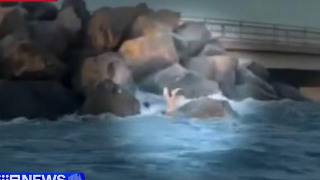 A boy was drowning, after falling from rocks and becoming caught in a rip about 20m from shore. Picture: 9 NEWS