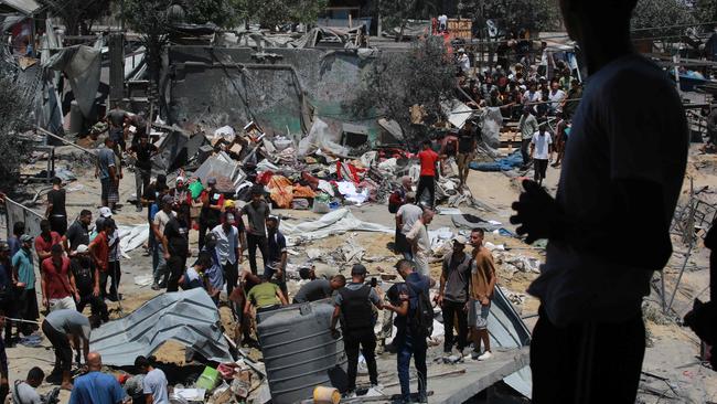 Palestinians look for survivors and bodies in the debris of tents and makeshift homes, following an Israeli military strike on the al-Mawasi camp for internally displaced people, near the city of Khan Younis, southern Gaza Strip, on Saturday Picture: Bashar Taleb / AFP