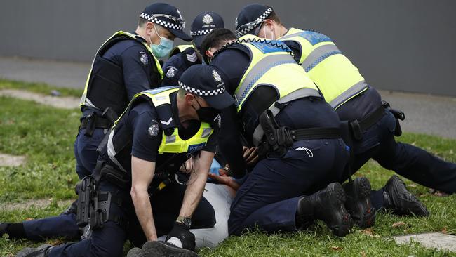 Police arrest a protester near Albert Park Lake in Melbourne last Saturday. Picture: NCA NewsWire/Daniel Pockett