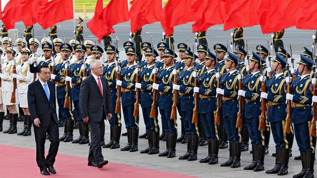 Prime Minister Malcolm Turnbull inspects the troops with Premier Li Keqiang outside Beijing’s Great Hall of the People on his first official visit to China. Picture: Stephen Cooper