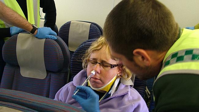 A passenger is treated after turbulence hit a Qantas flight from Hong Kong to Perth in 20