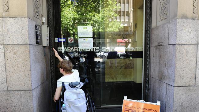 Vincent shows how difficult it can be for someone in a wheelchair to use the intercom at a building on King William St. Photo:Mark Brake