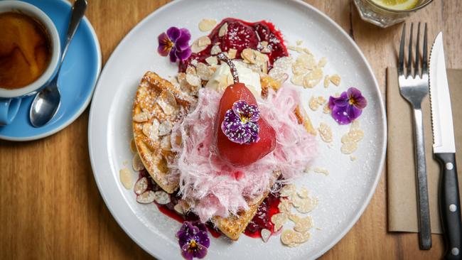 Forty Flips Cafe’s Belgian waffle with poached pear, berry compote and fairy floss. Picture: Nicole Cleary