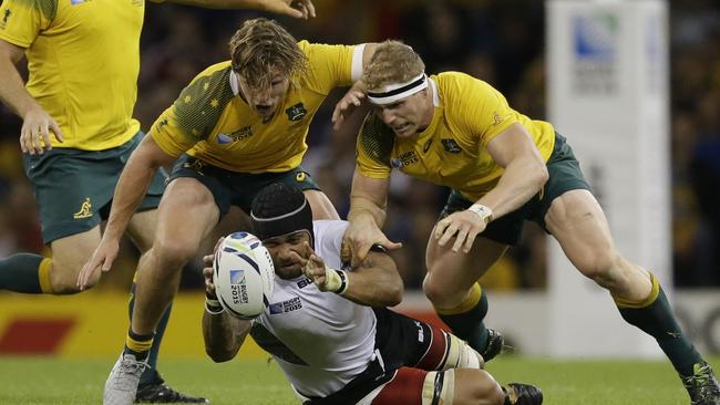 Fiji's Netani Talei is tackled by Australia's David Pocock, right, and Michael Hooper during the Rugby World Cup Pool A match between Australia and Fiji at the Millennium Stadium, Cardiff, Wednesday, Sept. 23, 2015. (AP Photo/Matt Dunham)