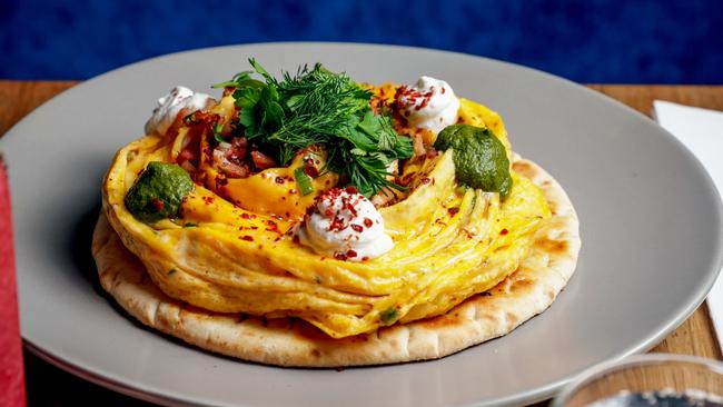 Ivy and Pearl Cafe’s chilli folded eggs on charred flatbread with fried bacon, Aleppo pepper, spring onion, Persian fetta and green harissa. Picture: Nicole Cleary