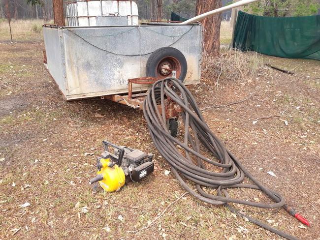 Helping a neighbour get his trailer and firefighting pump ready. Picture: John Steer