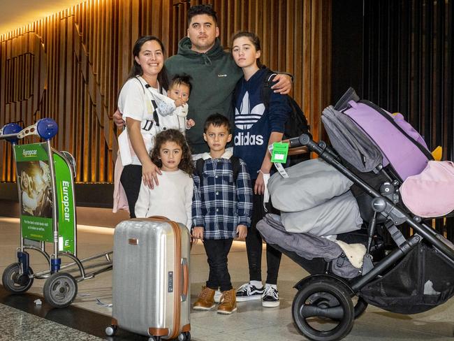 The Campbell family prepares to board a plane bound for New Zealand. Parents Cassandra and Steven with children Ellah, Elijah, Ethan and Ezra. Picture: Jake Nowakowski.