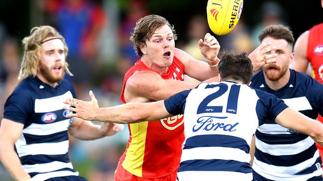 Gold Coast recruit Nick Holman gets a handball away. Picture: Alix Sweeney