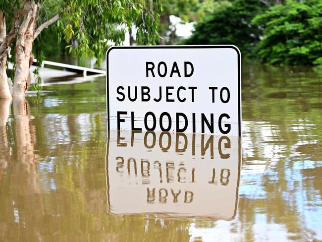 A sign is inundated by floodwater in Auchenflower, Brisbane on February 28. Picture: NCA NewsWire / Dan Peled