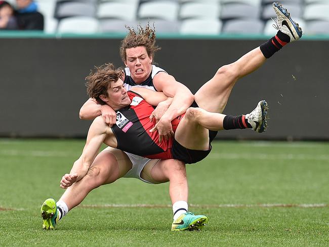 Matt Dornauf is brought down in a tackle by Cat Wylie Buzza. Picture: Nigel Hallett