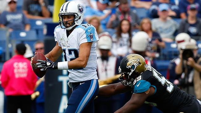 Charlie Whitehurst is pressured by Ryan Davis.