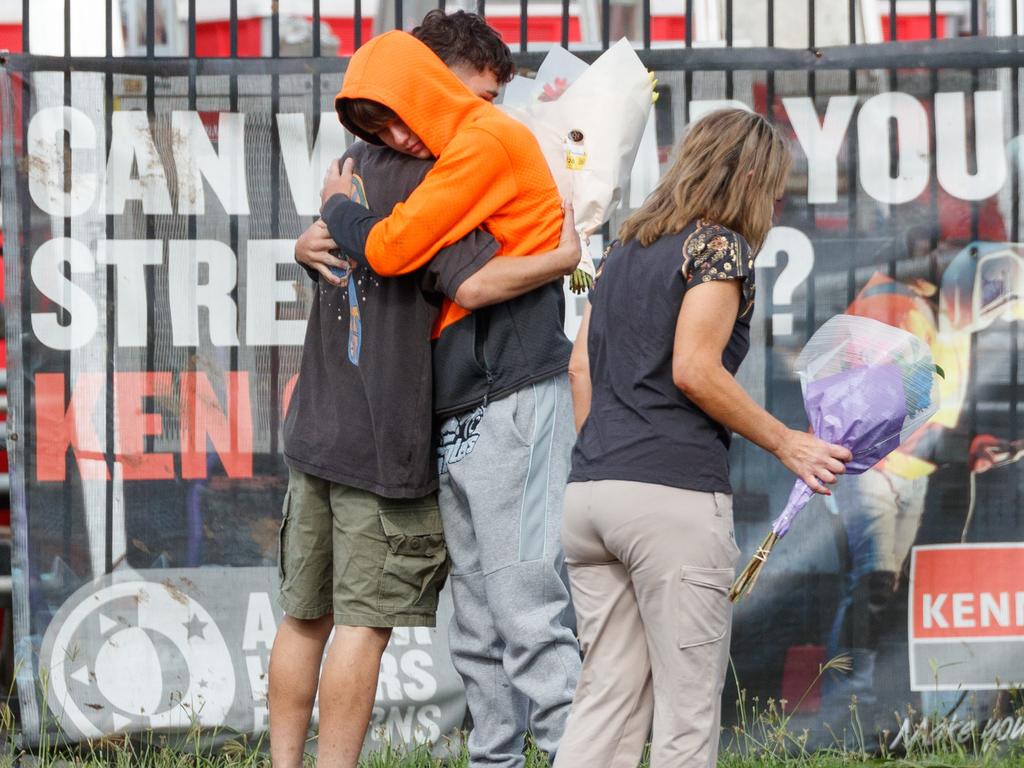 Young mourners console each other at the scene on Tuesday. Picture: Max Mason-Hubers