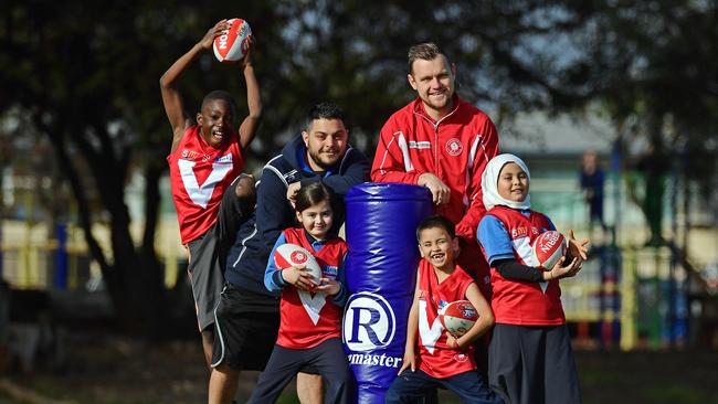 GAME ON: Pinnacle College students Mohammed, 10, Aaya, 6, Fyzan, 7, and Zeenat, 9, with their teacher Michael Triantafilakis and North Adelaide player Jason Rivett, are taking part in the SANFL Welcome to Australian Rules Football program. Picture: Tom Huntley