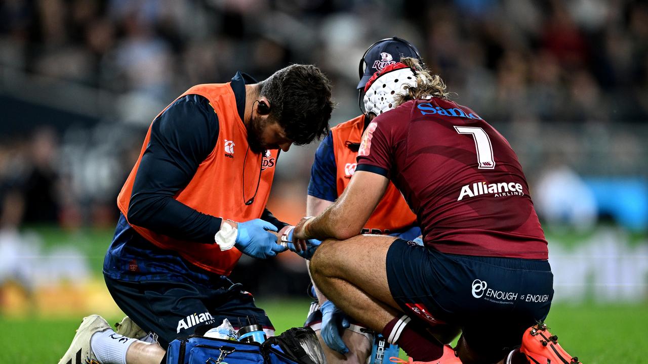 Reds flanker Fraser McReight receives attention during Queensland’s loss to the Highlanders. Picture: Joe Allison/Getty Images