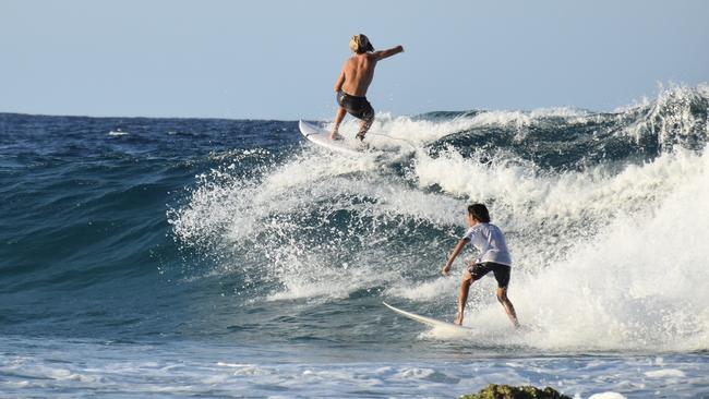 Young swimmers knocked down by swell at Snapper Rocks on the Gold Coast generated by Tropical Cyclone Oma. Picture: Mark Furler
