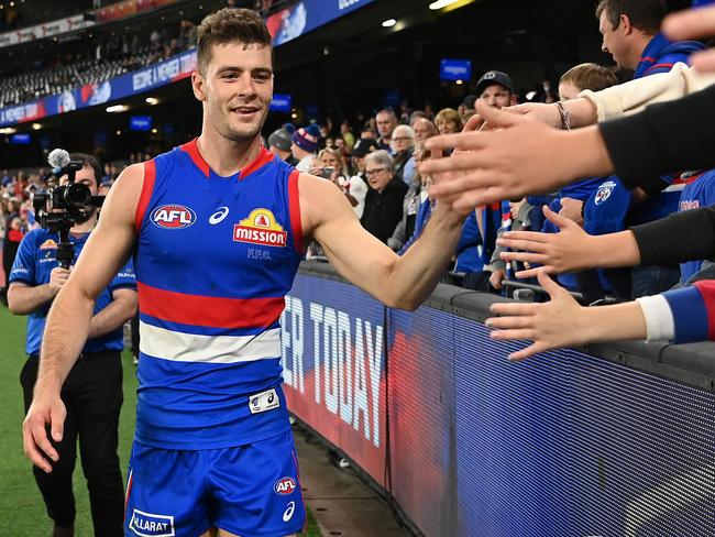 MELBOURNE, AUSTRALIA - MAY 01: Josh Dunkley of the Bulldogs high fives fans in his 100th game after winning the round seven AFL match between the Western Bulldogs and the Essendon Bombers at Marvel Stadium on May 01, 2022 in Melbourne, Australia. (Photo by Quinn Rooney/Getty Images)