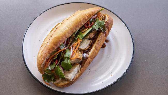 The pork crackling banh mi at Cafe O-Mai comes on a baguette made in-house. Picture: Mark Cranitch.