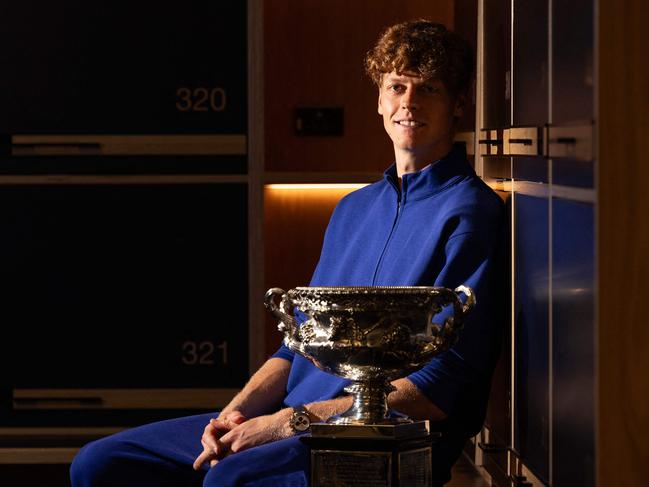 This handout picture released by Tennis Australia on January 27, 2025, shows Italy's Jannik Sinner poses with the Norman Brookes Challenge Cup trophy in a locker room after defeating Germany's Alexander Zverev during their men's singles final match on day fifteen of the Australian Open tennis tournament in Melbourne. (Photo by Fiona HAMILTON / AFP) / RESTRICTED TO EDITORIAL USE - MANDATORY CREDIT "AFP PHOTO / TENNIS AUSTRALIA / FIONA HAMILTON " - NO MARKETING NO ADVERTISING CAMPAIGNS - DISTRIBUTED AS A SERVICE TO CLIENTS