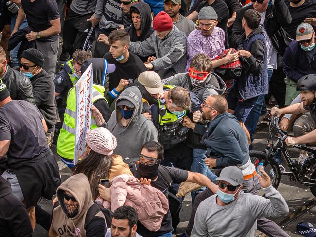 A protester screams in an officer’s face during the chaos. Picture: Jason Edwards