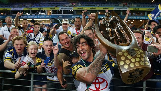 Cowboy's Johnathan Thurston holds the trophy in front of Cowboys fans after the 2015 NRL Grand Final between the Brisbane Broncos and North Queensland Cowboys at ANZ Stadium, Sydney. Pic Brett Costello