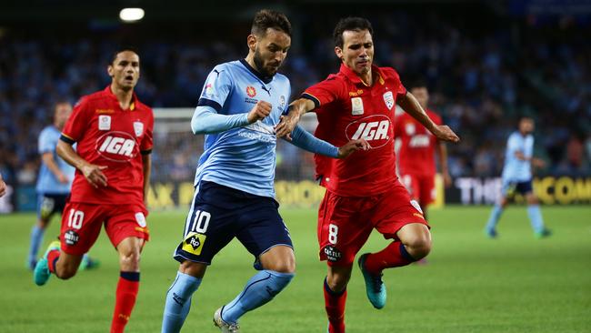 Milos Ninkovic of Sydney FC is challenged by Isaias of Adelaide United.