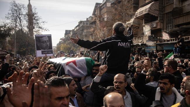 People carry the coffin of Mazen al-Hamada during his funeral in Damascus. Picture: Getty Images.